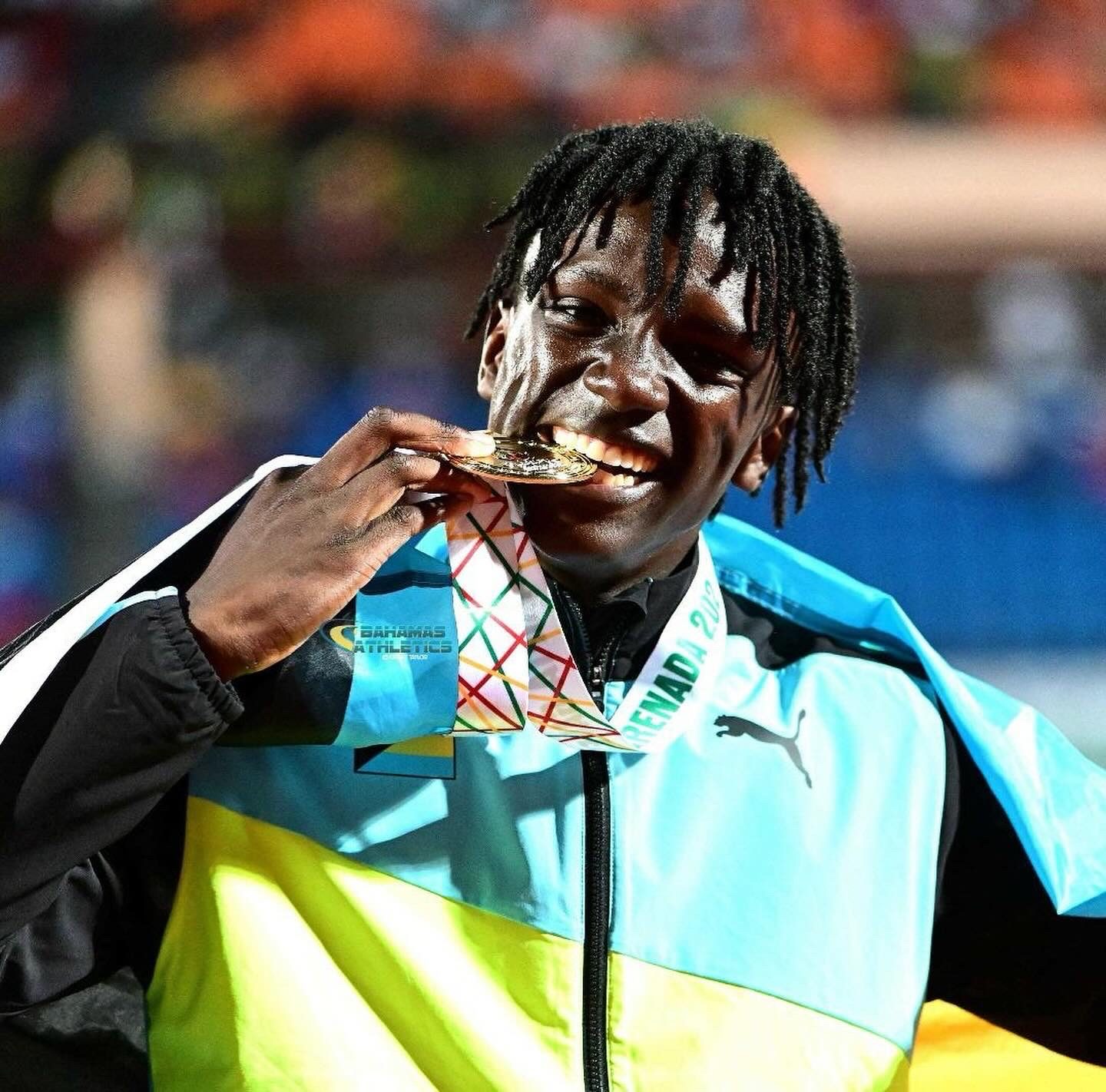 Brenden Vanderpool biting the CARIFTA gold medal, Nassau 2023