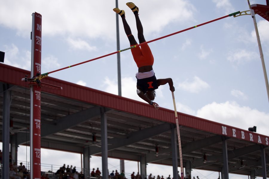 Brenden Vanderpool clearing the bar, clouds behind